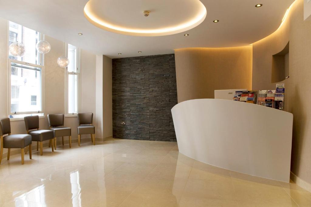 The Jade Hotel reception and lounge area with feature stone wall and natural light